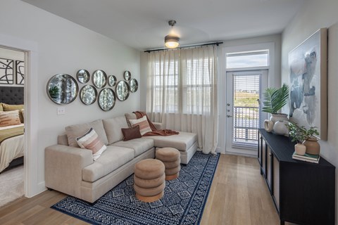 a living room with a couch and a door to a balcony